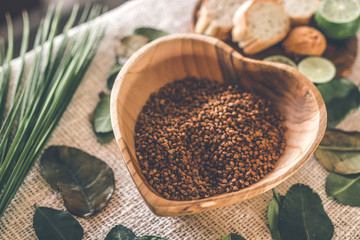 Teak Wooden bowl with buckwheat porridge on table. Traditional russian food. Lime and bread on the table.