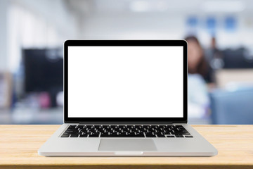 Laptop with blank screen on desk table with blur office interior background