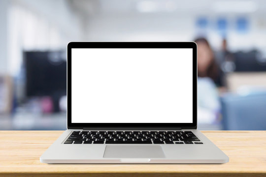 Laptop With Blank Screen On Desk Table With Blur Office Interior Background