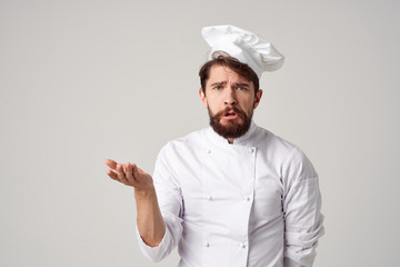 surprised chef man holds free kitchen space on his hand