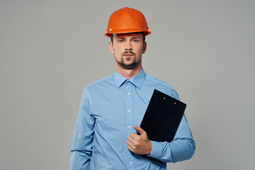 serious builder in an orange helmet