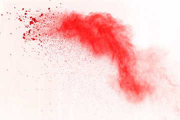 Abstract of red powder explosion on white background. Red powder splatted isolate. Colored cloud....