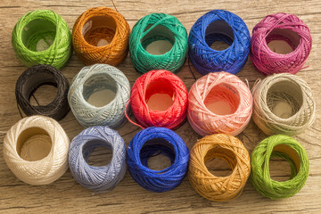 Colored balls of yarn. Multicolors. Yarn for knitting. Skeins of yarn. Crochet. Wooden Background