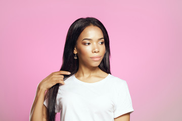 Fototapeta premium African woman in white t-shirt on pink background logo