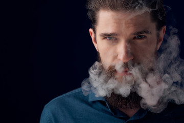 man with a beard on a black background smoke portrait