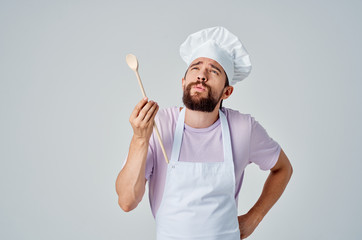 cook man with a wooden spoon