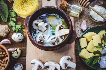 cooking mushrooms champignons with egg. Ingredients for cooking on a wooden background.