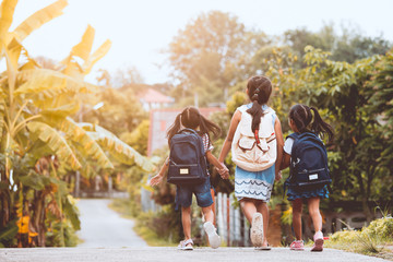Back to school. Asian  pupil kids with backpack going to school together in vintage color tone