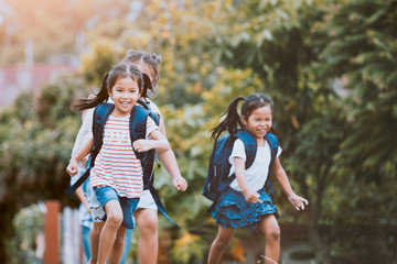 Back to school. Asian  pupil kids with backpack running and going to school together with fun and happiness in vintage color tone