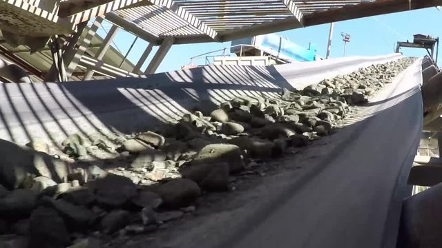 High definition video footage of a quarry equipment extracting rocks, sand, or gravel from the ground to produce materials for construction