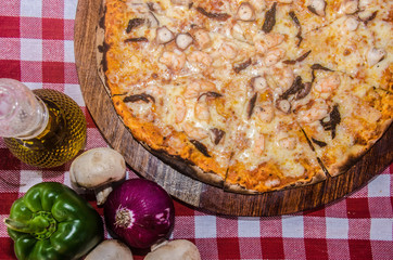 handmade seafood pizza prepared on a clay furnace pizza