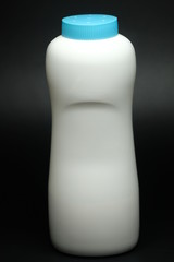 White plastic baby powder bottle isolated on black background