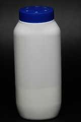 White plastic baby powder bottle isolated on black background