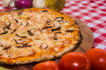 handmade seafood pizza prepared on a clay furnace pizza