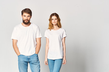 young couple in white shirts logo woman man