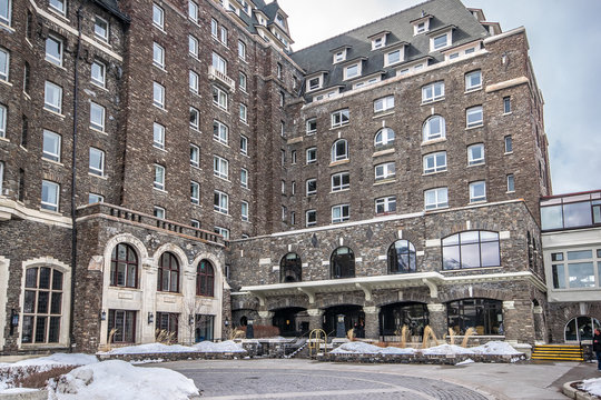 Exterior image of the Fairmont Banff Springs on a cold winter day. The stone, arched windows and interesting roof peaks make this place look like a castle.