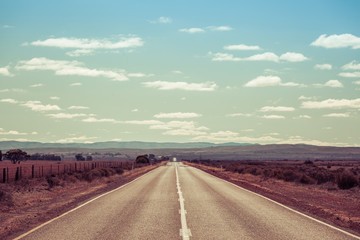 Fototapeta na wymiar Rural highway passing through South Australian countryside on bright sunny day
