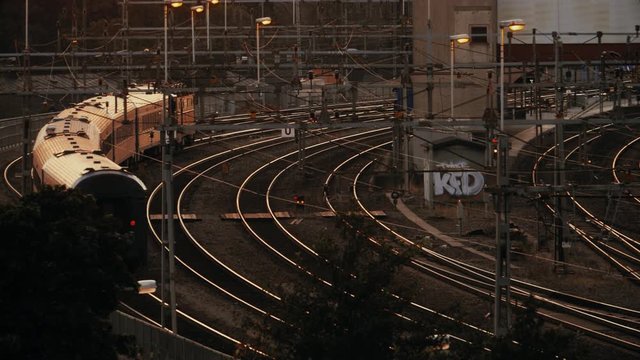 A Passenger Train Slowly Makes its Way into a Station in Stockholm, Sweden in the Evening