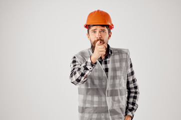 builder in an orange helmet and a transparent waistcoat