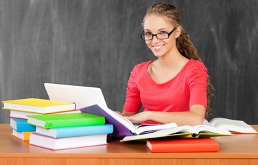 Young female college student and stack book