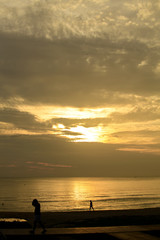 Fototapeta premium People stood watching the sea, Sunrise and happy