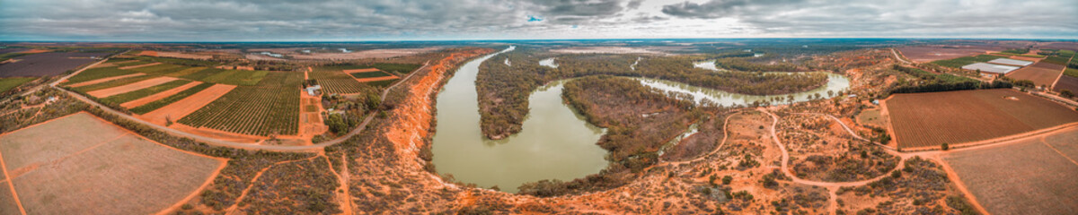 Wide aerial panorama of agricultural fields and winding iconic Murray River in Riverland region of...