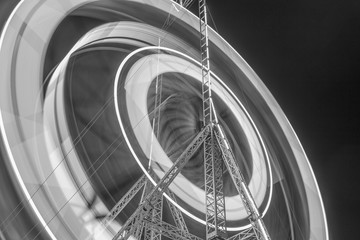 Side show of giant ferris wheel in black and white photography