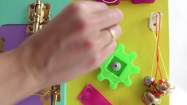 demonstration of torque parts on visibone. Woman playing with children's educational toy