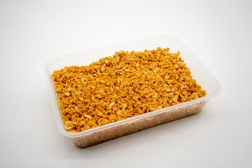 Deep fired garlic in clear plastic container isolated on white