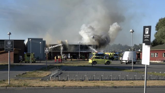 4k Footage of fire at school in very sunny and warm day in Norway, Akershus, Lillestrom, lillestr&oslash;m.
Fire department and police is trying to take out the fire.