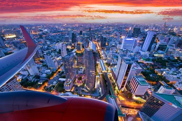 Zelfklevend Fotobehang Travel transportation concept by Airplane is flying over Bangkok city skyline with beautiful landscape during at dusk. © newroadboy