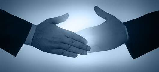 Businessman giving his hand for handshake to partner