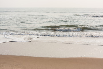 Foamy waves on calm beach - Foamy sea waves on a calm tropical beach in the morning.