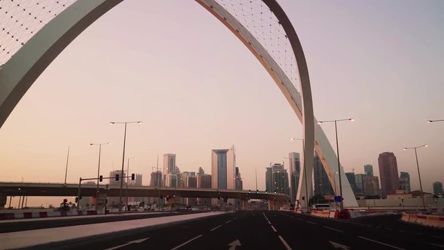 Morning drive through Arc Intersection and revealing West Bay skyline in Doha, Qatar