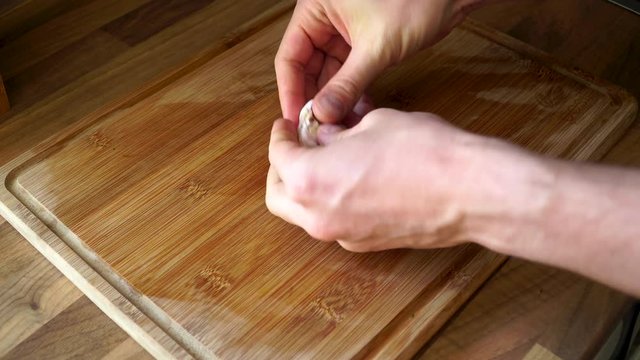 Cutting garlic on a cutting board in the kitchen.