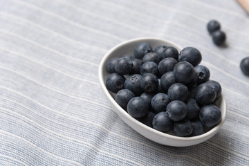 Blueberry fruits in white bowl
