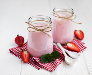 Jars with strawberry yogurt