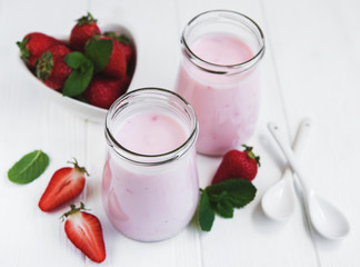 Jars with strawberry yogurt