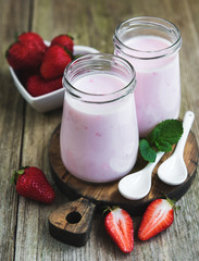 Jars with strawberry yogurt
