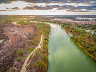 Fototapeta na wymiar Aerial view of majestic Murray River flowing among islands of gum trees at sunset in South Australia