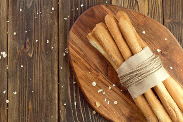 Crispy bread sticks on wooden table