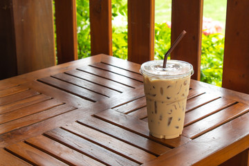 Fototapeta na wymiar Iced coffee on a wooden table in the garden.