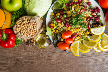 Healthy food background ,fruits and vegetables with salad bowl on wooden table.