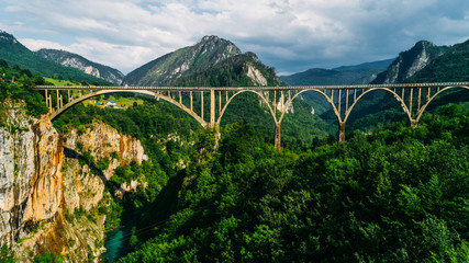 Aerial View of Durdevica Tara Arc Bridge in the Mountains, One of the Highest Automobile Bridges in Europe. - obrazy, fototapety, plakaty