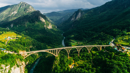 Aerial View of Durdevica Tara Arc Bridge in the Mountains, One of the Highest Automobile Bridges in Europe. - obrazy, fototapety, plakaty