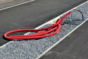 Repair of communications. cable outlet in corrugated red caviar for lamppost in the park