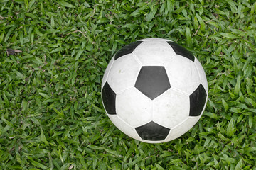Fototapeta na wymiar Soccer ball on green grass soccer field.