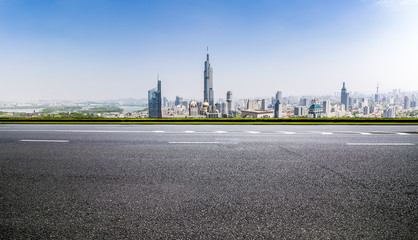 Obraz premium Panoramic skyline and modern business office buildings with empty road,empty concrete square floor