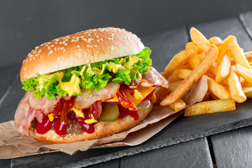 Hamburger with fries on a slate plate