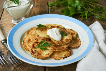 Fried zucchini with sour cream and fresh herbs